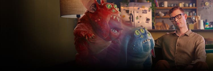 Creature and man sitting next to one another on a couch