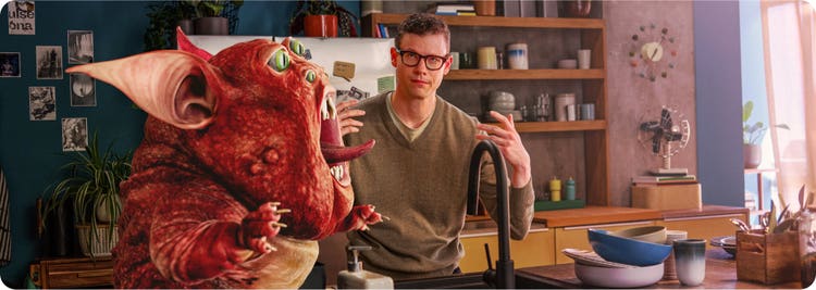 Man in a kitchen with an illustrated depiction of a creature